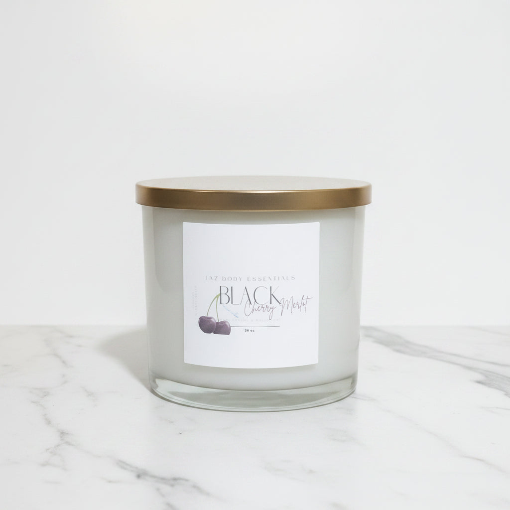 Candle jar with a gold lid on a marble surface