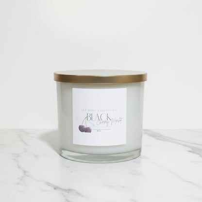 Candle jar with a gold lid on a marble surface