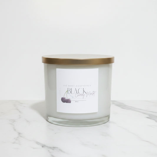 Candle jar with a gold lid on a marble surface
