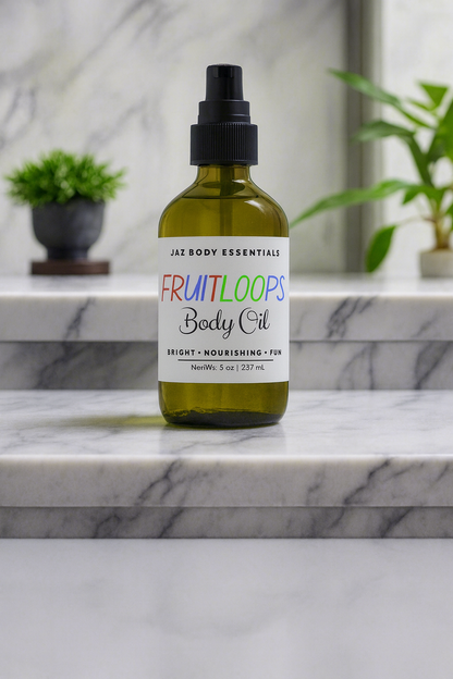 Body oil bottle labeled 'Fruitloops' on a marble surface with plants in the background