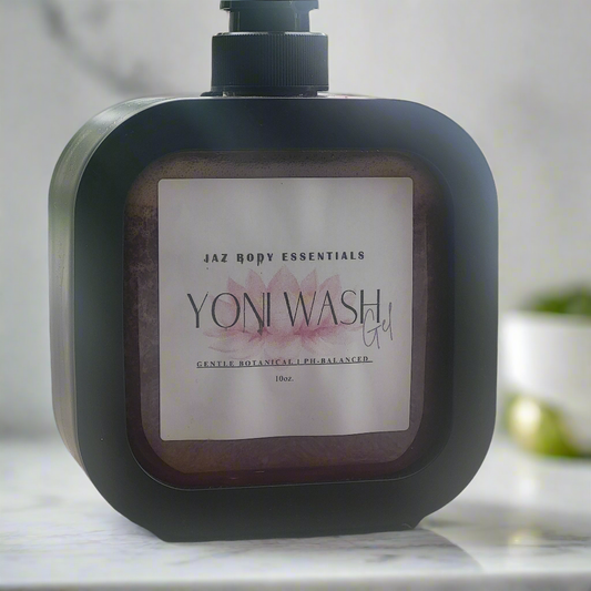 Bottle of Jaz Body Essentials Yoni Wash Gel on a marble surface with a blurred background