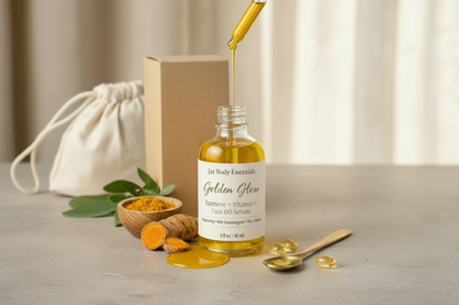 Bottle of 'Golden Glow' face oil serum on a wooden surface with turmeric, oranges, and towels.