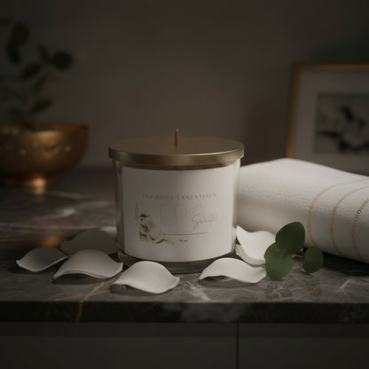 Candle with a gold lid and white label on a white background