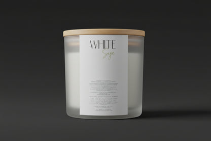 White candle labeled 'White Sage' on a surface with a blurred background