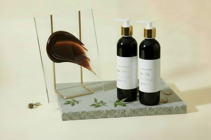 Black bottle with white pump on a gray surface