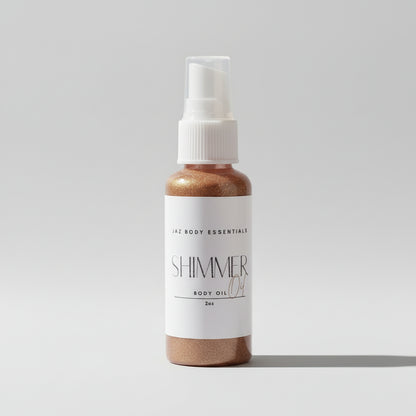 A bottle of shimmer body oil with a spray nozzle, standing on a sunlit surface which appears to be either sand or a textured road.