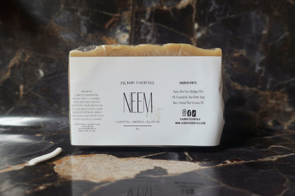 Bar of soap with a label on a marble surface